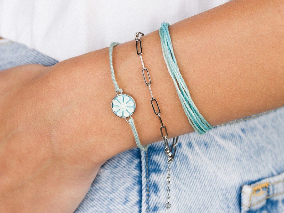 hand holding Pura Vida Coastal Cloud Pack