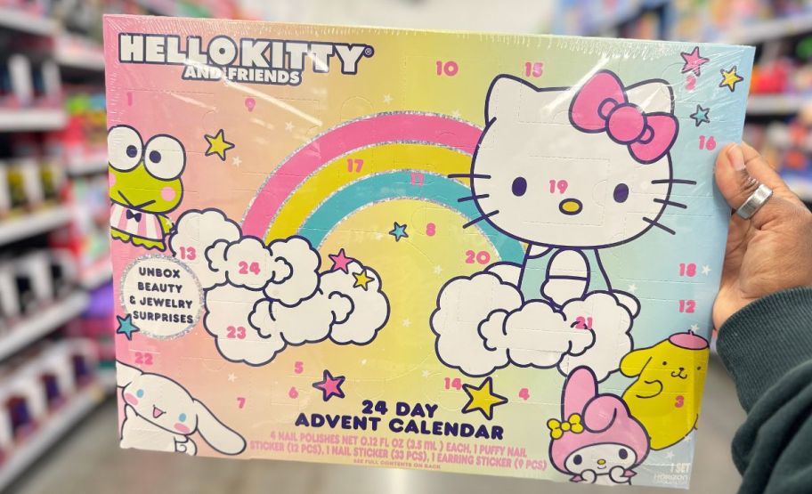 a womans hand holding a hello kitty advent calendar