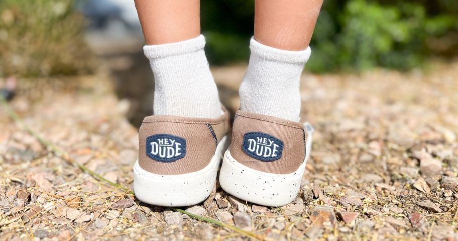 kid wearing heydude shoes outside