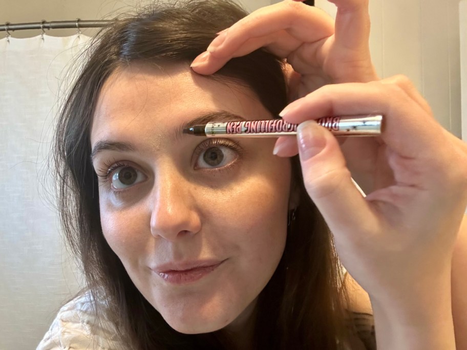 woman applying brow liner