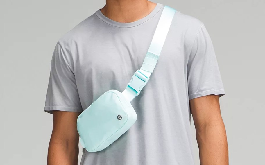 man in a grey tee with a light blue lululemon belt bag