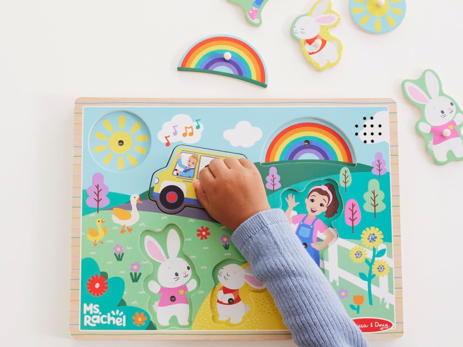 child playing with a wooden puzzle