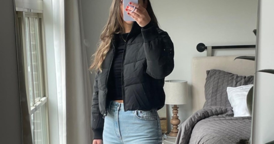 woman taking selfie in black cropped jacket