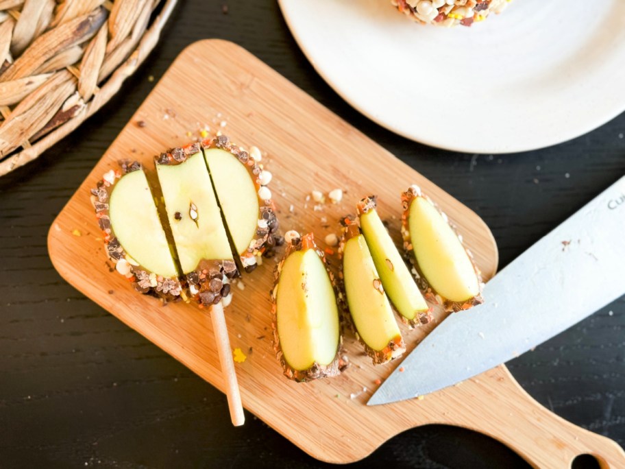 cut slices of mrs prindables caramel apples displayed on a cutting board with a chef's knife