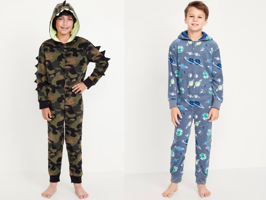 two boys wearing dinosaur and space one piece pajamas