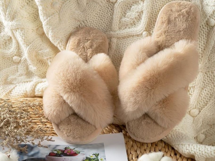 a pair of Parlovable camel slippers next to a blanket