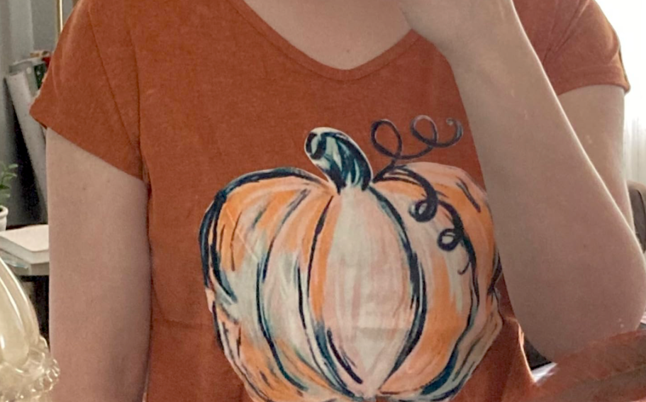 Woman wearing pumpkin shirt 