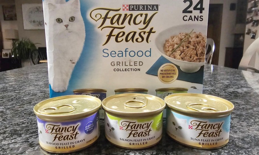 fancy feast seafood 24 pack box with three cans in front of it on counter