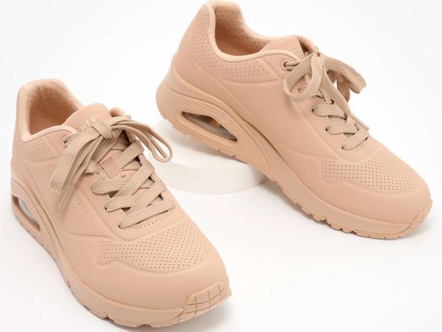 tan pair of sketchers sneakers 