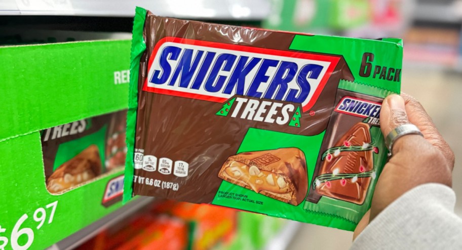 snickers trees 6 pack displayed in womans hand