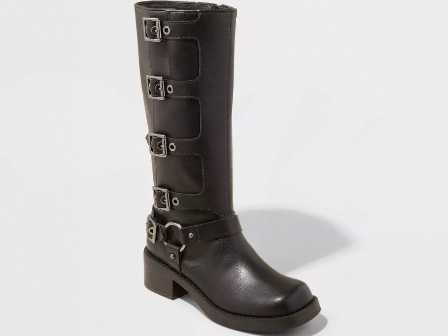 tall black boot with buckles stock image