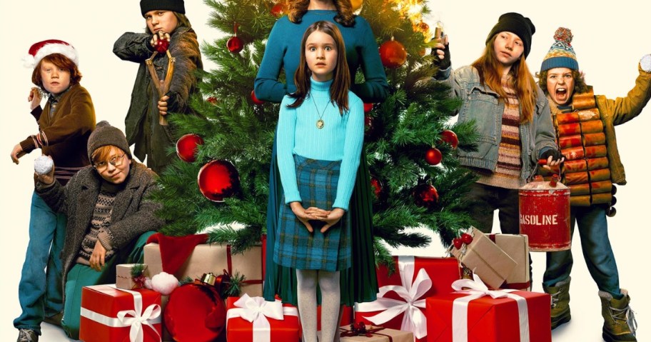 kids standing in front of a Christmas tree with presents, some boys are throwing snowballs or have slingshots