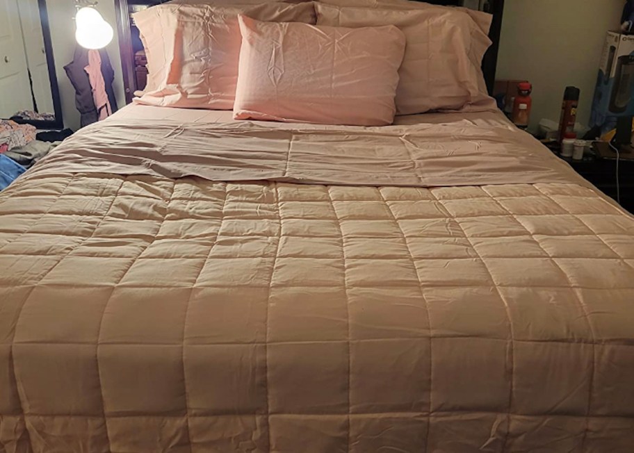 pink quilted onlineforter on bed