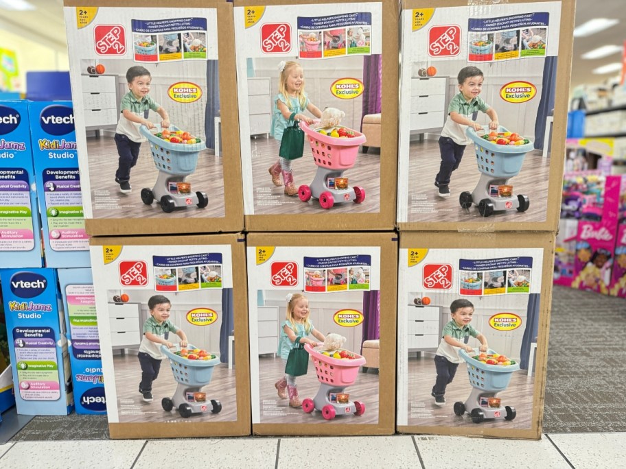 boxes with kid's Step 2 toy shopping carts in store