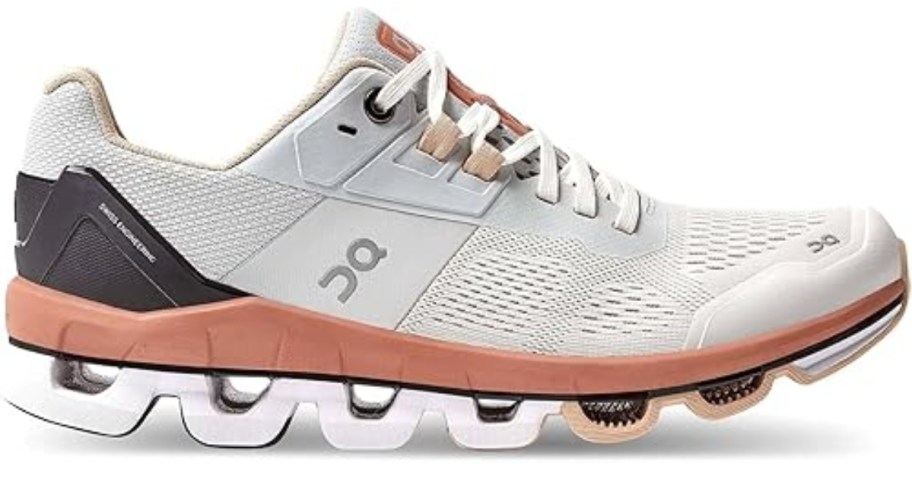 white, orange, grey, and black women's On Cloud running shoe