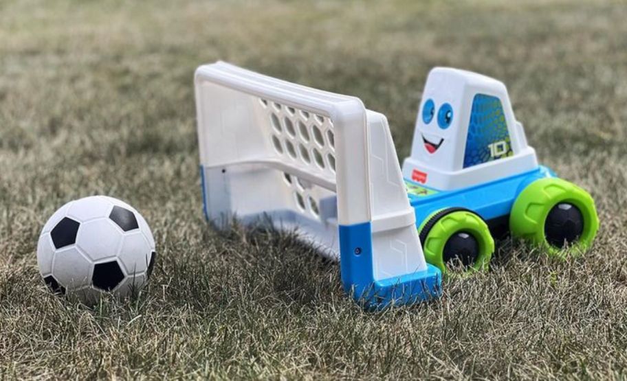 a fisher price goaldozer toy in the grass