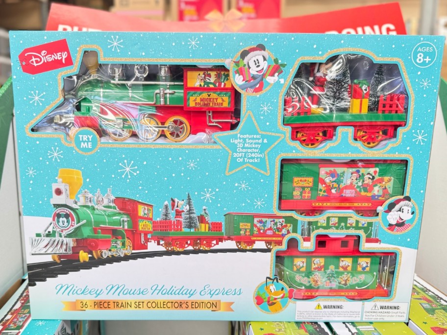 large blue box with a 36-Piece Battery Operated Mickey Mouse Holiday Express Train on a store display