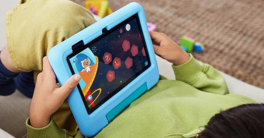 boy holding a blue fire kids tablet