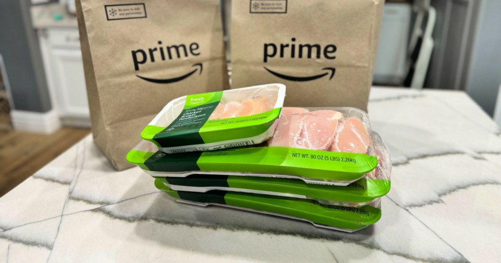 packaged chicken breasts in counter in front of Amazon paper bags