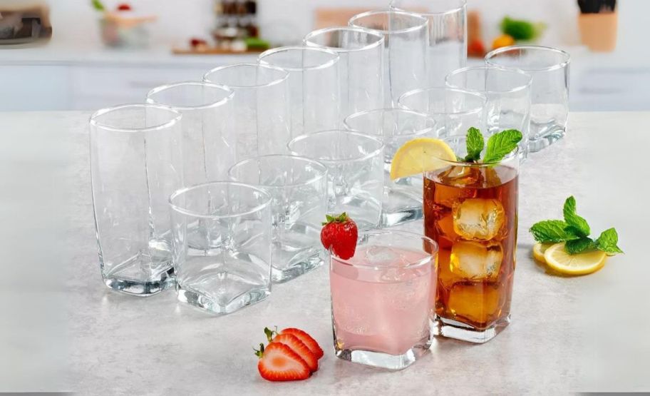 a 16 piece set of drinkware on a kitchen counter