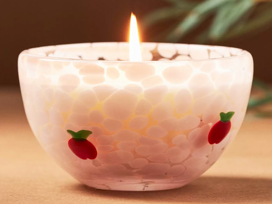 candle in a glass bowl with apple print