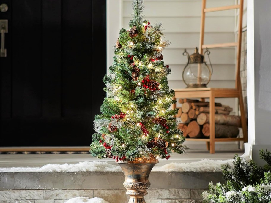 pre-lit mini Christmas tree on porch