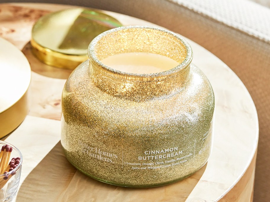 gold glittery jar candle on side table