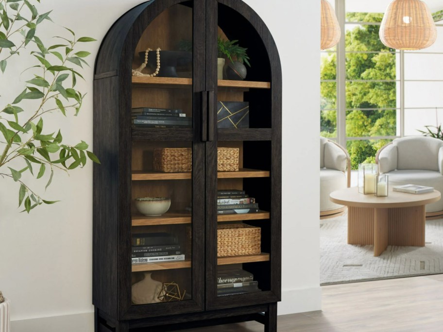 Black arched cabinet in living room