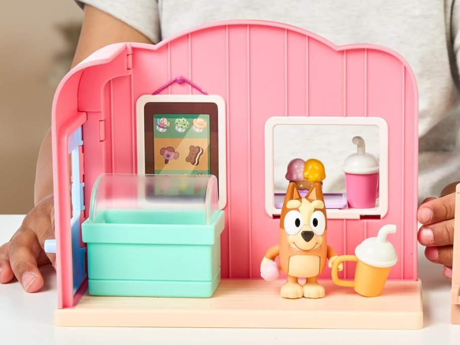 Boy playing with a Bluey Ice Cream Shop playset