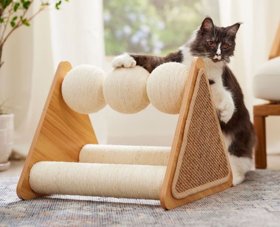 a cat scratching on a triangular scratching post