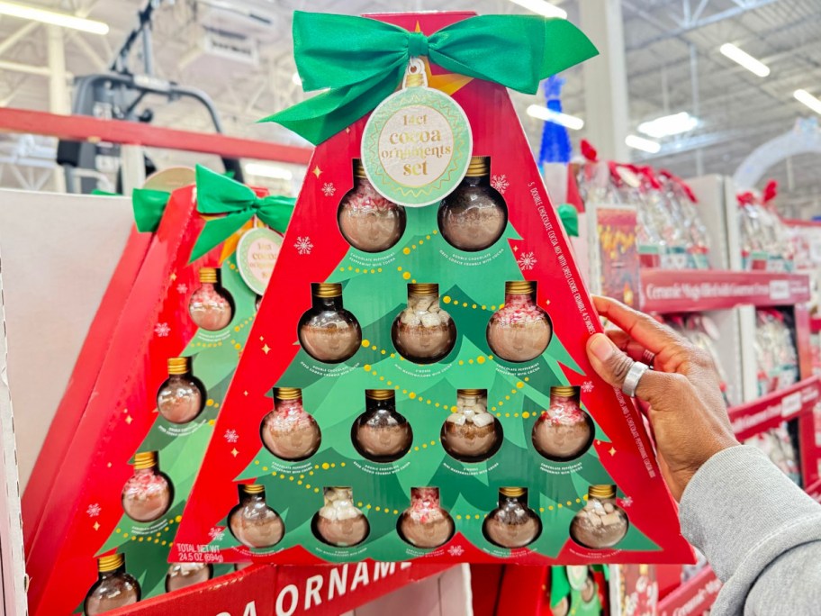 Christmas ornaments set in womans hand displayed at the store