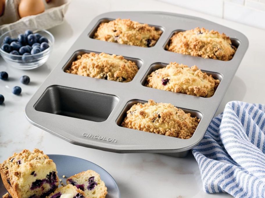 Circulon Nonstick Bakeware 6-Cup Mini Loaf Pan on kitchen counter with muffins inside