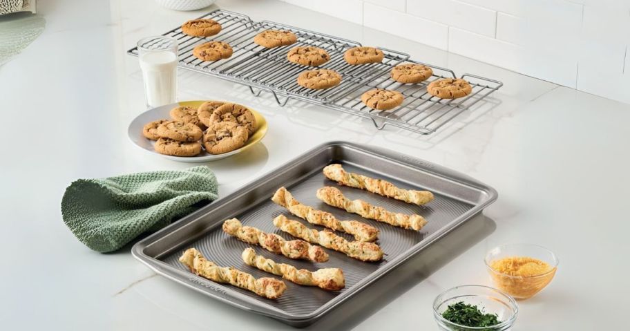 Circulon Total Bakeware Nonstick Cookie Baking Sheets w/ Cooling Rack on kitchen counter with breadsticks and cookies on them