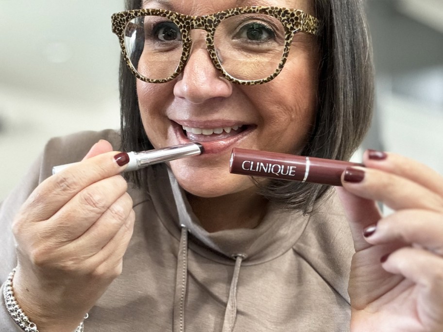 Woman applying Clinique Black Honey Lipstick