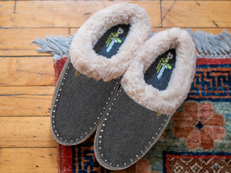 grey pair of slipper clogs on rug