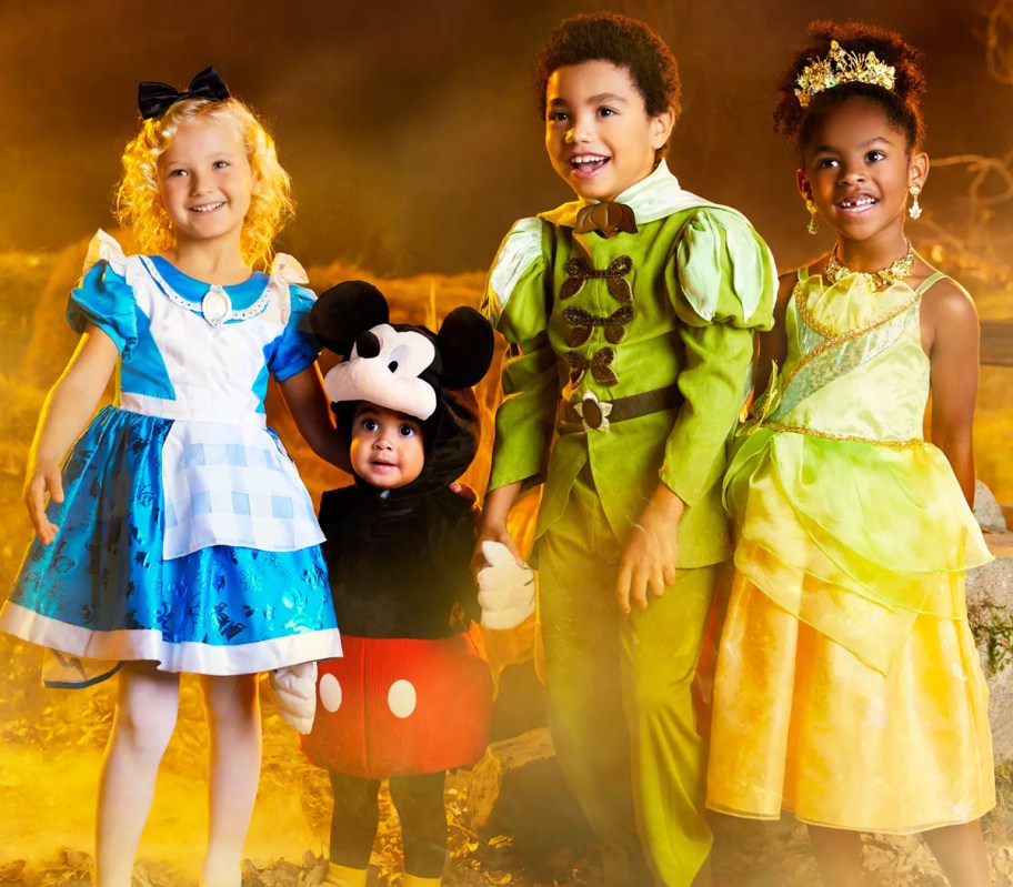 four kids in disney halloween costumes