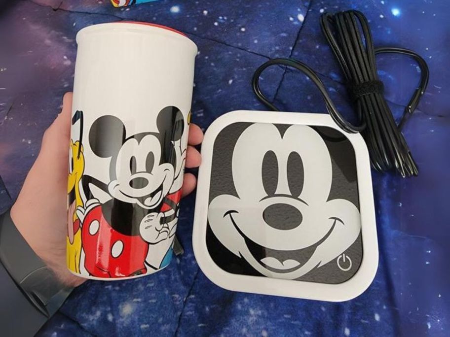 hand holding Disney's Mickey & Friends Mug Warmer