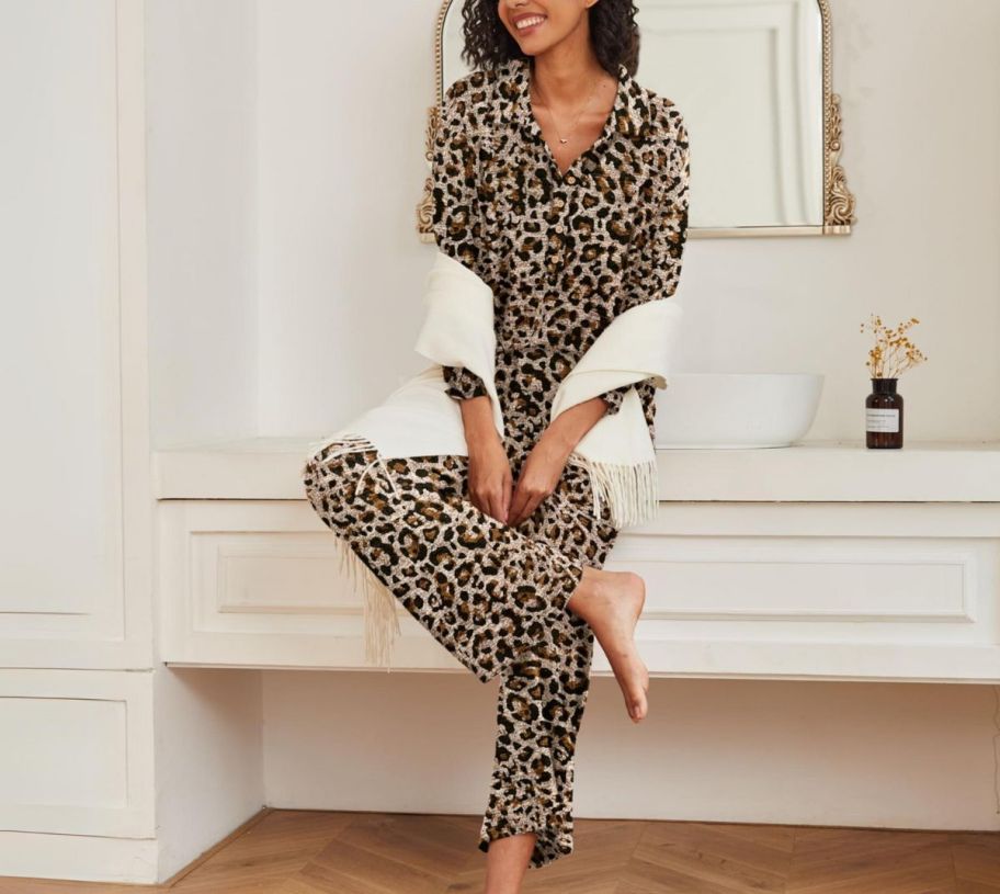 a woman in a set of leopard print pajamas