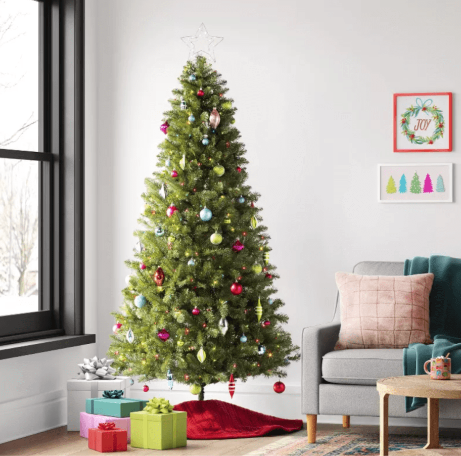 Faux Christmas Tree from Target set up in a living room and decorated with christmas ornaments