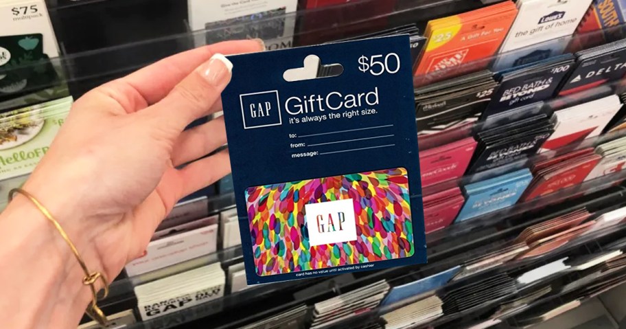 hand holding up a GAP gift card in store