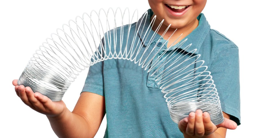 boy playing with a slinky toy