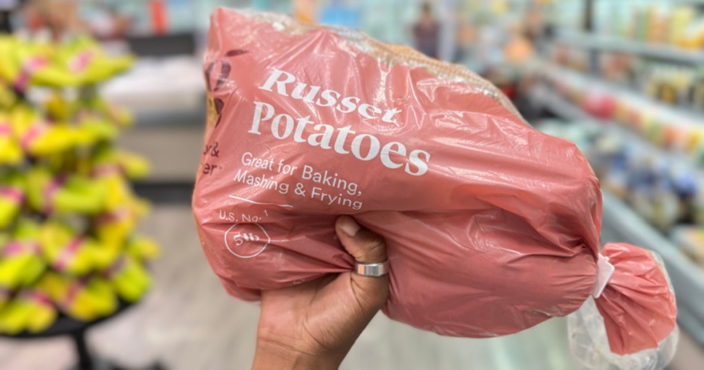 person holding up Good & Gather Russet Potatoes – 5lb bag in target store