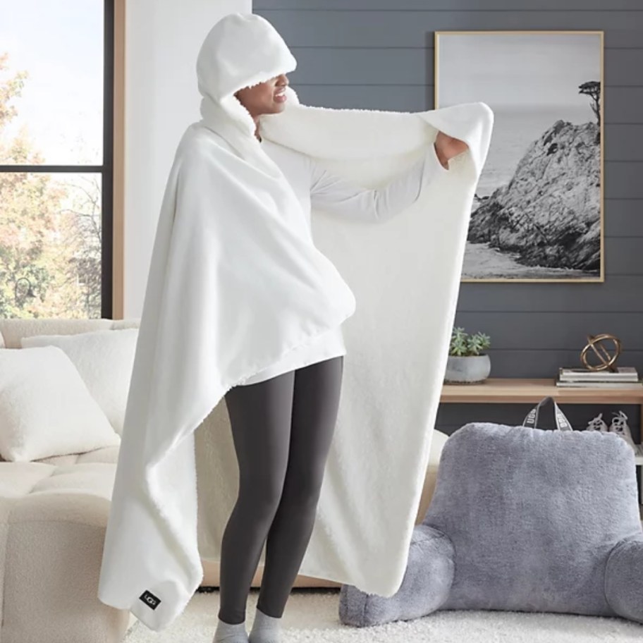 person wearing a white hooded UGG blanket