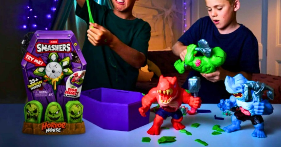 little boys playing with a ZURU Smashers dinosaur monsters toy set