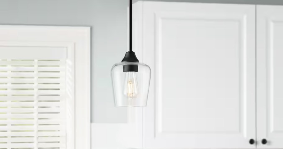 black pendant light with glass shade in kitchen