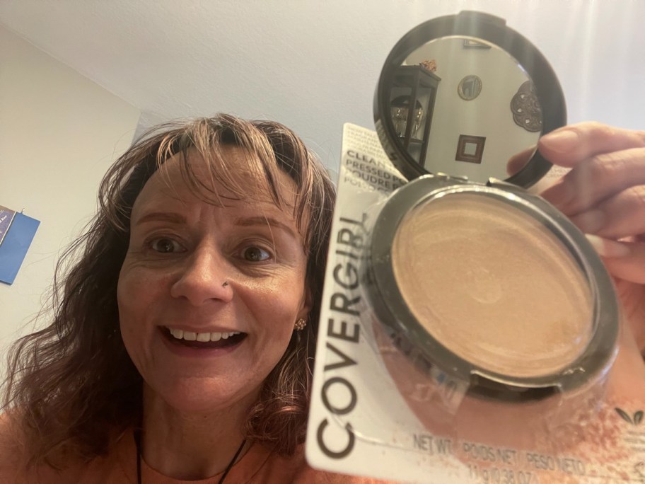 Happy Friday reader holding up her makeup haul of covergirl powder from cvs