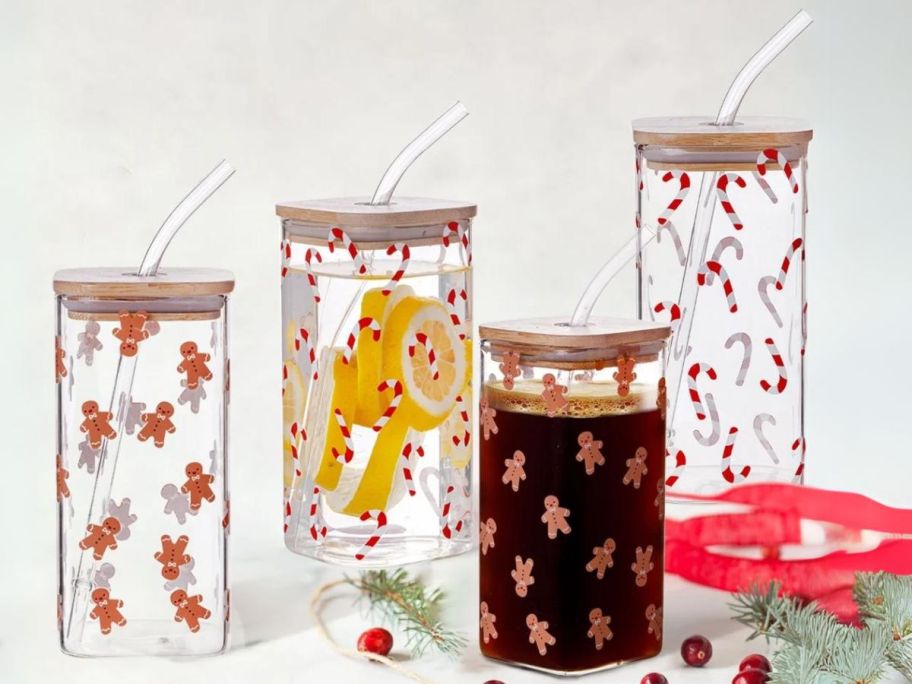 Holiday Time Gingerbread Man & Candy Cane Square Glass Sipper 4-Piece Set with cranberries and ribbon around it