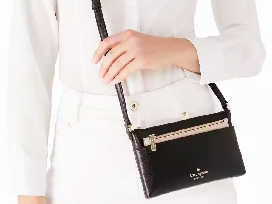 woman in a white outfit with a black crossbody bag