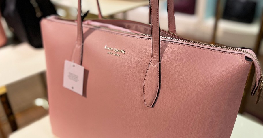 pink kate spade tote bag on display in store