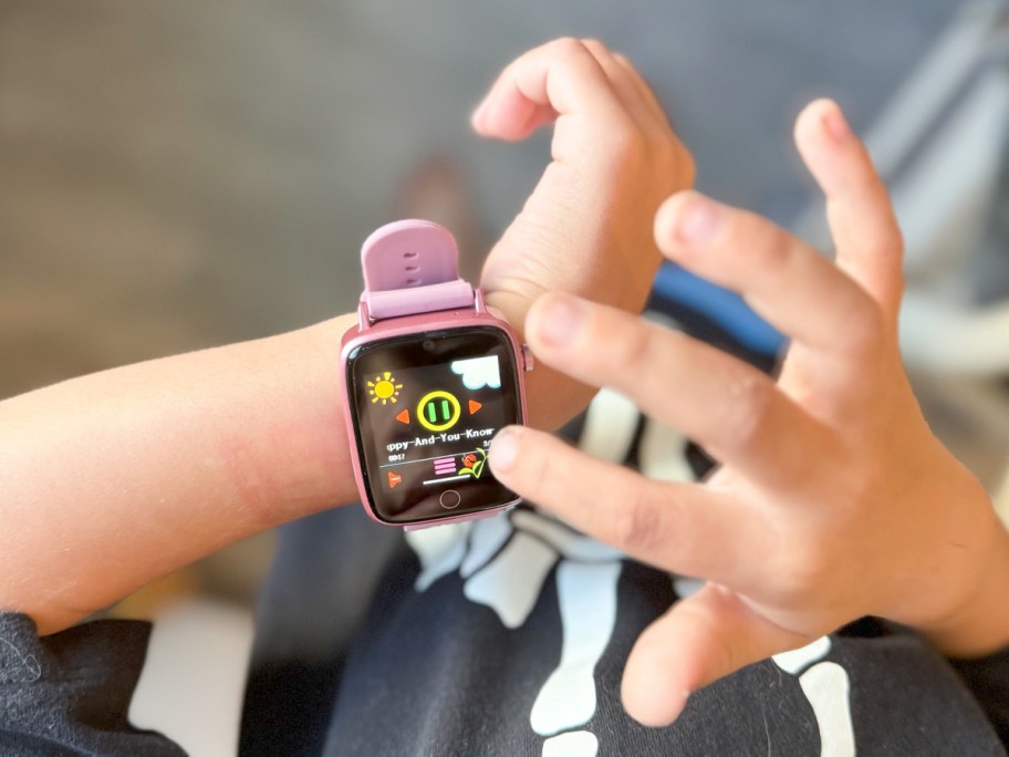 Kid scrolling on his smart watch